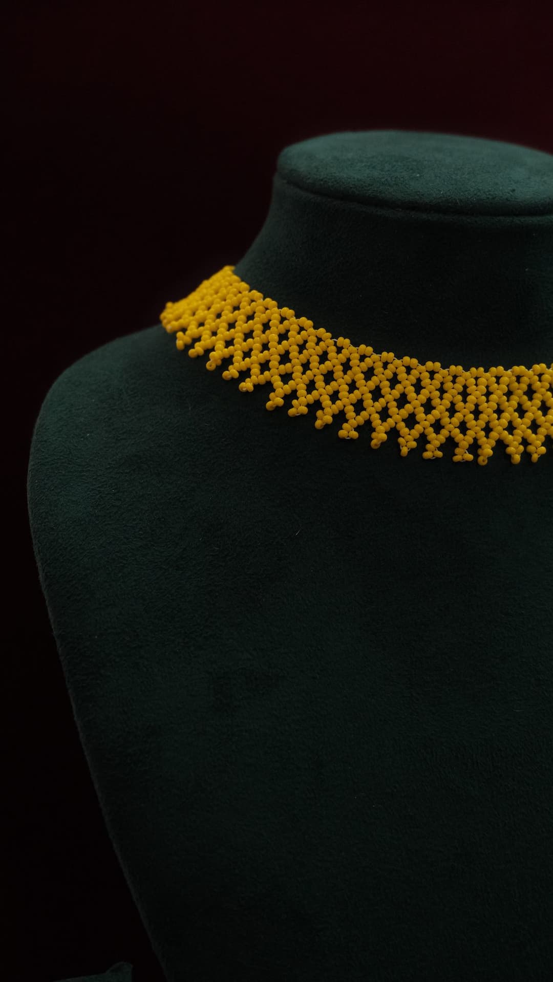 A wide woven net collar in marigold